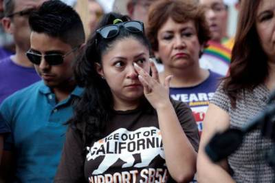 Diana, a Deferred Action for Childhood Arrivals (DACA) program recipient wipes away a tear listening to the parent of a DACA recipient speak during a rally outside the Federal Building in Los Angeles, California, U.S., September 1, 2017.