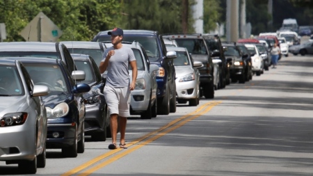 Motorists form a long line to get sandbags at Kissimmee, Fla., on Thursday to prepare for the arrival of Hurricane Irma.