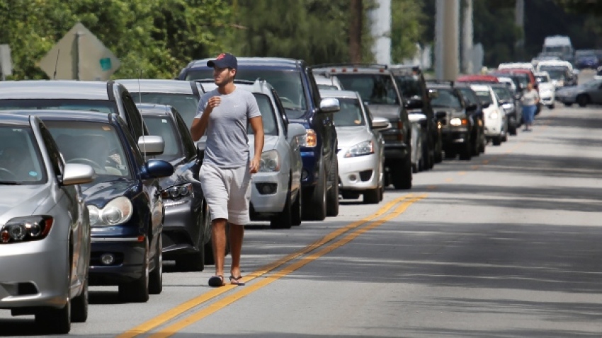 Motorists form a long line to get sandbags at Kissimmee, Fla., on Thursday to prepare for the arrival of Hurricane Irma.