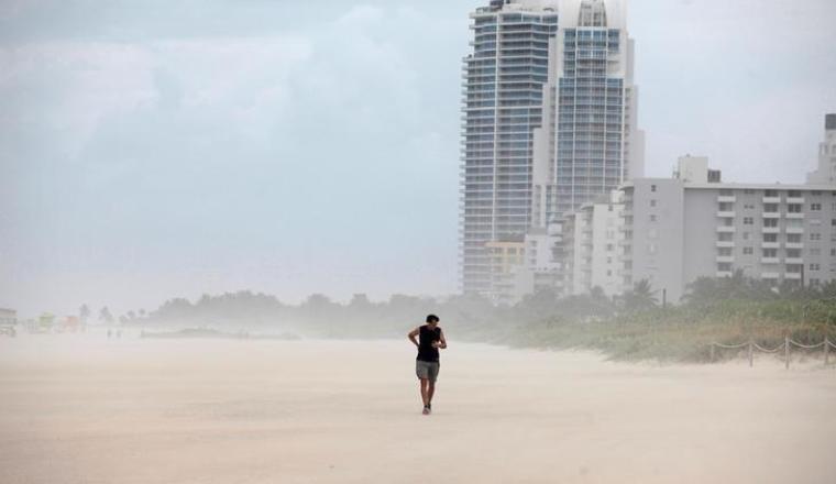 A person walks along the beach prior to the arrival of Hurricane Matthew in Miami Beach, Florida, U.S. October 6, 2016.