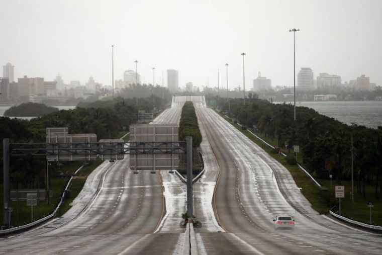 A car drives along an empty highway in Miami before the arrival of Hurricane Irma to south Florida, September 9, 2017.