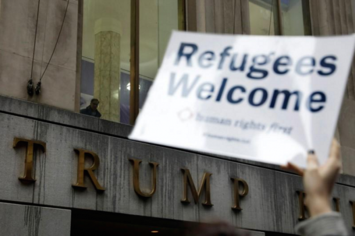 Protesters gather outside the Trump Building at 40 Wall St. to take action against America's refugee ban in New York City, U.S., March 28, 2017.