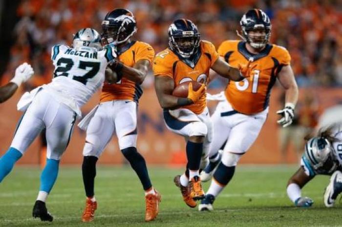 Denver Broncos running back C.J. Anderson (22) runs the ball as wide receiver Jordan Norwood (11).