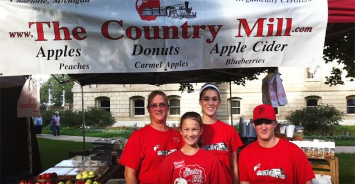 Representatives of Country Mill Farms at a city of East Lansing farmers' market. In May 2017, Country Mill filed a lawsuit against East Lansing over the city banning them because of their refusal to host same-sex weddings on their property.