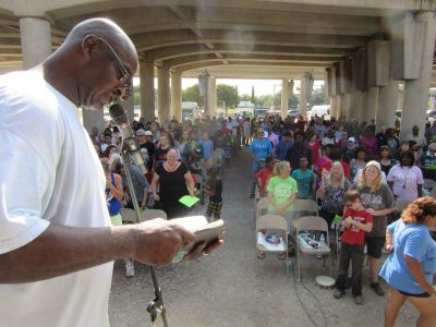Charles Benson, associate pastor at Church Under the Bridge in Waco, Texas, reads from the Bible as part of their 25th-anniversary worship celebration on Sunday, September 17, 2017.