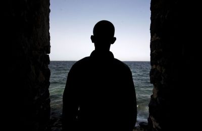 A man is silhouetted in the 'Door of No Return' at the House of Slaves on Goree Island near Senegal 's capital Dakar, March 16, 2007.