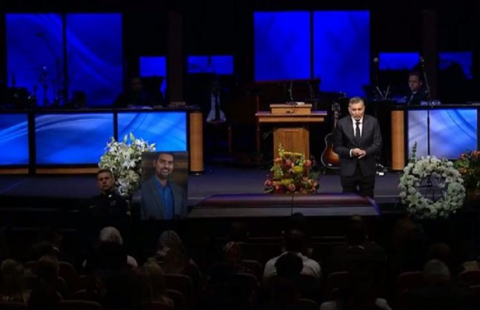 Jim Tour prays at Christian apologist Nabeel Qureshi's funeral service in Houston, Texas, on September 21, 2017.