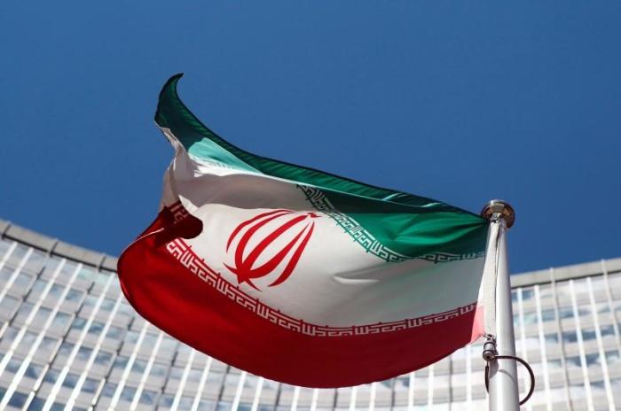 An Iranian flag flutters in front of the United Nations headquarters in Vienna, Austria, June 17, 2014.