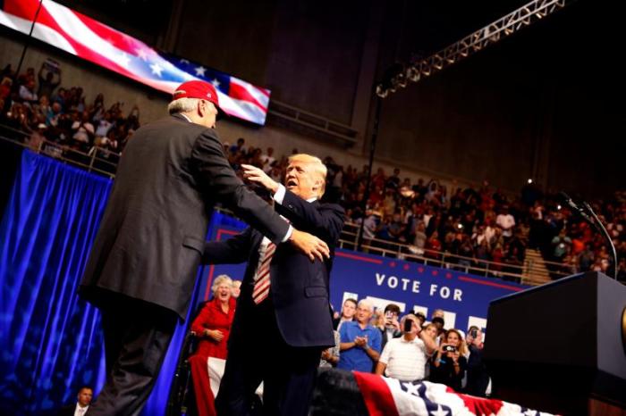 President Donald Trump greets Senator Luther Strange during a campaign rally in Huntsville, Alabama on Sept. 22, 2017.