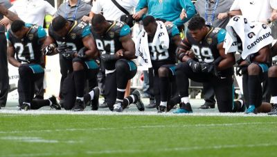Jacksonville Jaguars players kneel during the U.S. national anthem before their game against the Baltimore Ravens on Sept. 24, 2017 at Wembley Stadium in London, England.