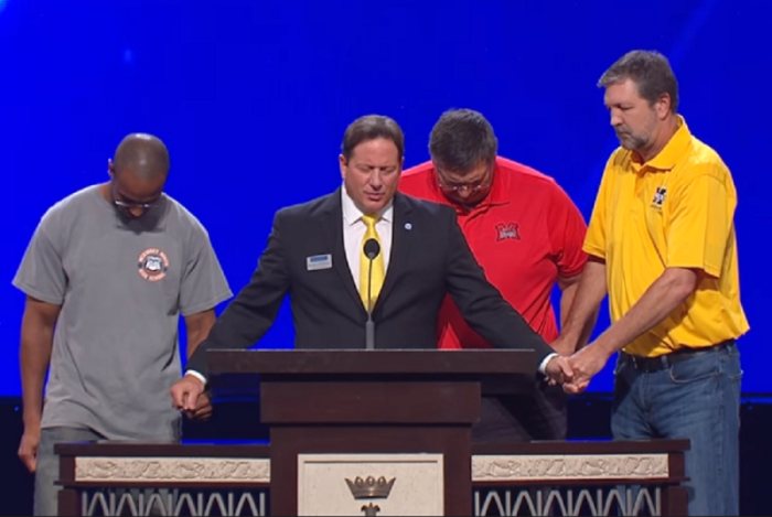 McKinney Independent School District Superintendent prayers with school district employees during a convocation held in August 2017 at Prestonwood Baptist Church in Plano, Texas.
