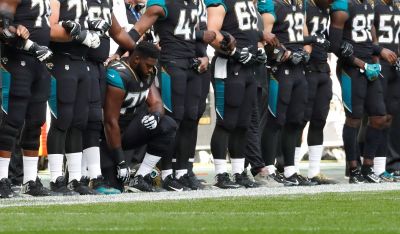 Patrick Omameh of the Jacksonville Jaguars kneels during the U.S. national anthem before the match, Jacksonville Jaguars vs Baltimore Ravens, Wembley Stadium, London, Britain, September 24, 2017.