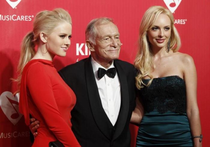 Anna Berglund (L), Hugh Hefner (C), and Shera Bechard pose at the 2012 MusiCares Person of the Year tribute honoring Paul McCartney in Los Angeles, February 10, 2012.
