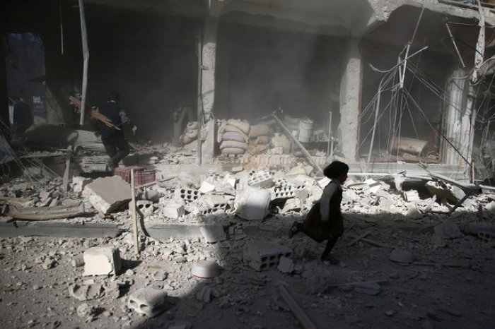 Credit : A girl runs past a damaged site after an airstrike in the besieged rebel-held town of Douma, eastern Ghouta in Damascus, Syria November 2, 2016.