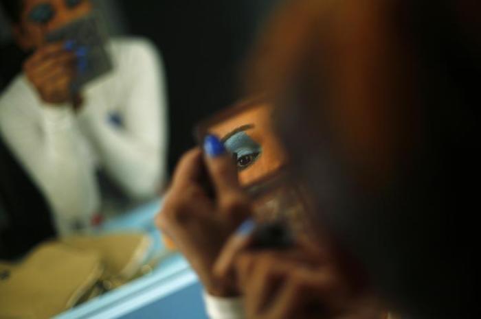 An aspiring model does her make up before auditioning for a transgender/transsexual modelling agency set to open in New Delhi, February 7, 2016.