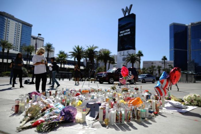 A woman looks at a makeshift memorial on the Las Vegas Strip for victims of the Route 91 music festival mass shooting next to the Mandalay Bay Resort and Casino in Las Vegas, Nevada, U.S. October 3, 2017.