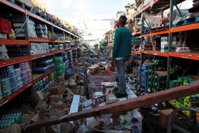 A man stands inside of a destroyed supermarket by Hurricane Maria in Salinas, Puerto Rico, September 29, 2017