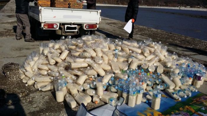 International Christian Concern works with a partner organization to provide rice through bottles for North Koreans in this undated photo.