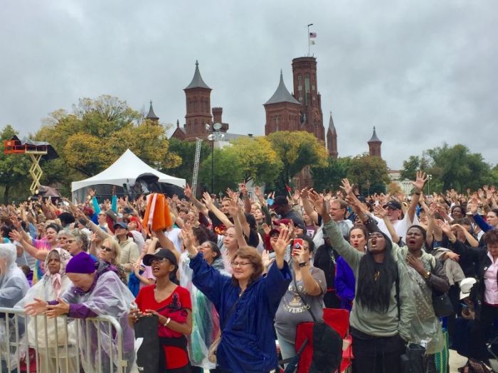 Christians gathered for The Call's Rise Up rally sing and lift their hands in worship on the National Mall in Washington, D.C. on October 9, 2017.
