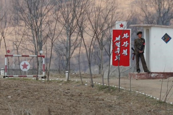 A North Korean soldier guards the gate on banks of the Yalu River, north of Sinuiju, North Korea, April 1, 2017.