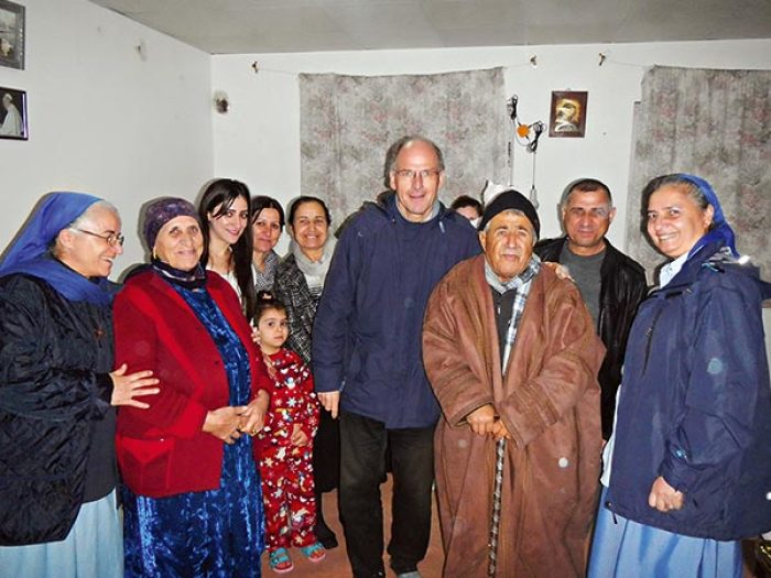 Andreas Knapp and two Little Sisters of Jesus visiting a family from Qaraqosh, Iraq, now living in Iraqi Kurdistan in this undated photo.
