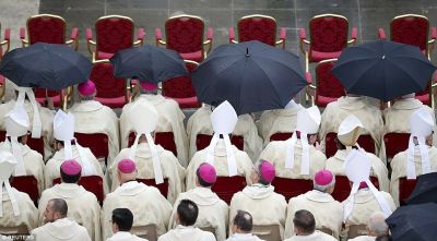 Bishops waits under umbrellas before Pope Francis opens a Catholic Holy Year, or Jubilee, in St. Peter's Square, at the Vatican, December 8, 2015.