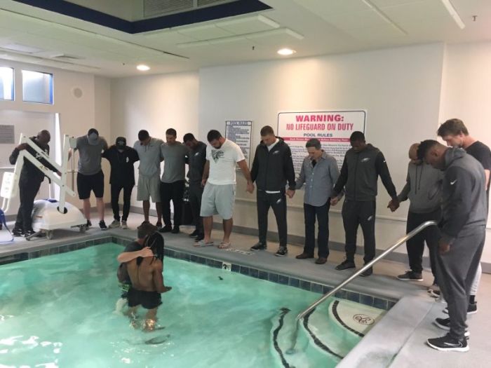 Wide receiver Marcus Johnson get's baptized in hotel pool before football game, Oct 12, 2017.