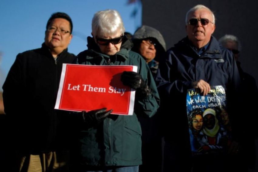 Demonstrators hold an "Interfaith Prayer Vigil for Immigrant Justice" outside the federal building, where ethnic Chinese Christians who fled Indonesia after wide scale rioting decades ago and overstayed their visas in the U.S. must check-in with ICE, in Manchester, New Hampshire, U.S., October 13, 2017.