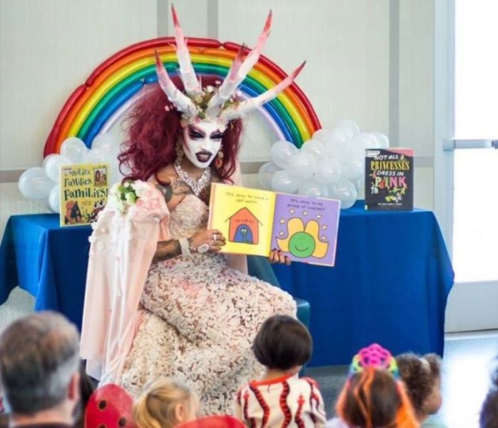 A drag queen who goes by the name Xochi Mochi reads a story to children at the Michelle Obama Neighborhood Library in Long Beach, California, on October 14, 2017.