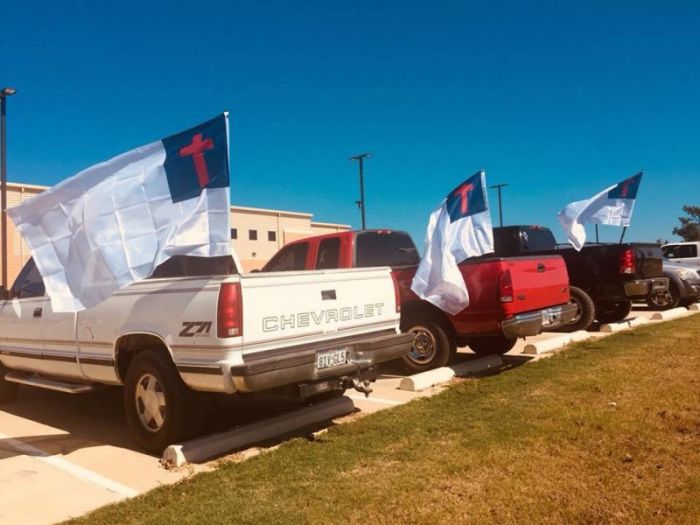 Christian flags fly on the back of students' pickup trucks at LaPoynor High School in Larue, Texas, in this photo posted to Facebook on October 18, 2017.