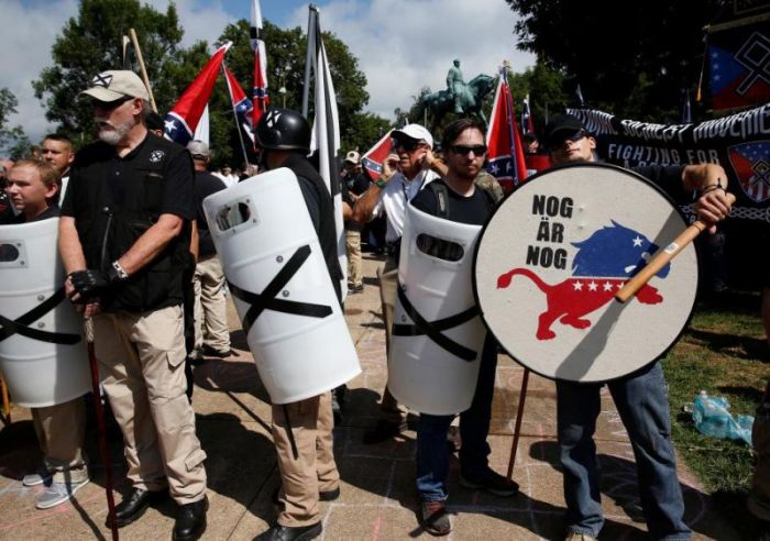 White supremacists stand behind their shields at a rally in Charlottesville, Virginia, U.S., August 12, 2017.