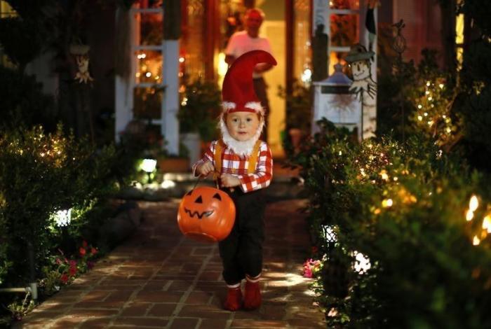 A boy collects candy as he goes trick-or-treating for Halloween in Santa Monica, California, October 31, 2012.