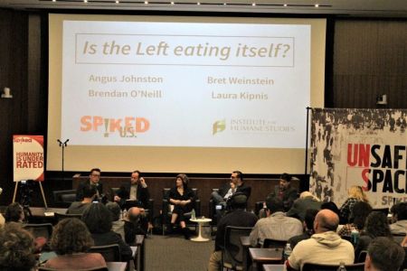 Tom Slater (L), deputy editor of Spiked introduces a panel of speakers at an 