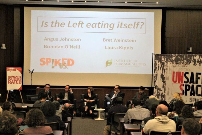 Tom Slater (L), deputy editor of Spiked introduces a panel of speakers at an 