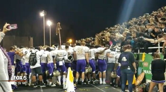 Players on the East Coweta High School football team in Georgia gather to pray before their game against Newnan High School on Nov.3, 2017.