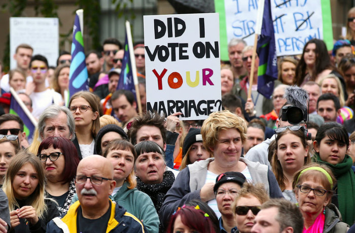 People carry banners and signs as they participate in a marriage equality march in Melbourne, Australia, August 26, 2017.