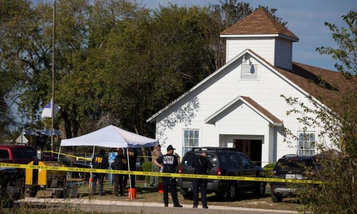 Law enforcement officials investigate a mass shooting at the First Baptist Church in Sutherland Springs, November 6, 2017.