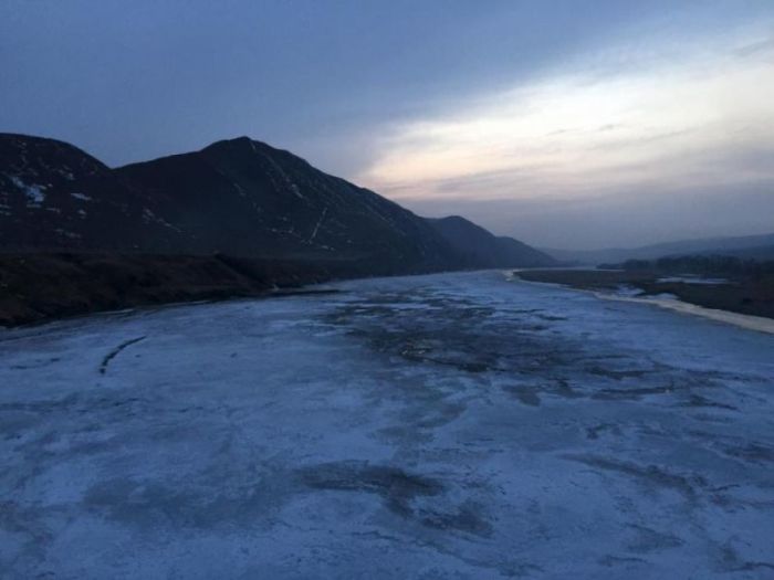The frozen Tumen river separating North Korea (L) from China is seen in this photo taken from the Chinese border city of Tumen, China, March 18, 2015. It's much more dangerous, and twice as expensive, to defect from North Korea since Kim Jong Un took power in Pyongyang, refugees and experts say, and far fewer people are escaping from the repressive and impoverished country.
