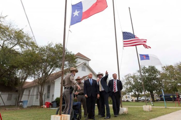 Vice President Mike Pence, Texas Gov. Greg Abbott and law enforcement officials stand outside the First Baptist Church of Sutherland Springs, Texas on Wednesday November 8, 2017. Some 26 members of the church were executed and another 20 seriously wounded inside the sanctuary during worship services on Sunday November 5, 2017 in what is now the worst mass shooting in Texas' history.