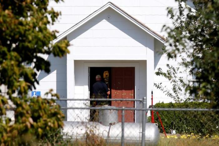 A law enforcement officer enters the First Baptist Church of Sutherland Springs.