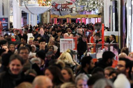 Bargain-hunters walk through Macy's Herald Square store during early opening for Black Friday sales in Manhattan, New York, Nov. 24, 2016.