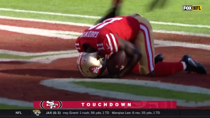 Marquise Goodwin of the San Francisco 49ers gets on his knees after scoring a touchdown, Nov. 12, 2017.