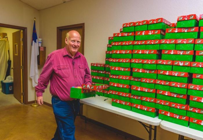 Pastor Mark Brumbelow of Grace Baptist Church in Wild Peach, Texas holds an Operation Christmas Child shoebox in this undated photo.