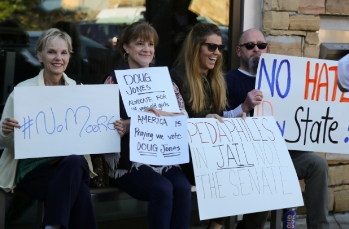 Protesters await Judge Roy Moore outside the Mid-Alabama Republican Club's Veterans Day Program in Vestavia Hills, Alabama, U.S., November 11, 2017.