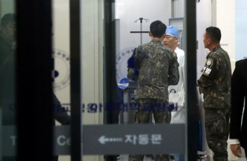 A South Korean soldier talks with a surgeon at a hospital where a North Korean soldier who defected to the South is hospitalized.
