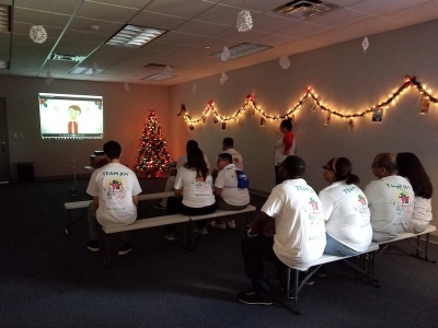 Box of Joy volunteers receive brief training before they head into the warehouse, Nov 18, 2017.