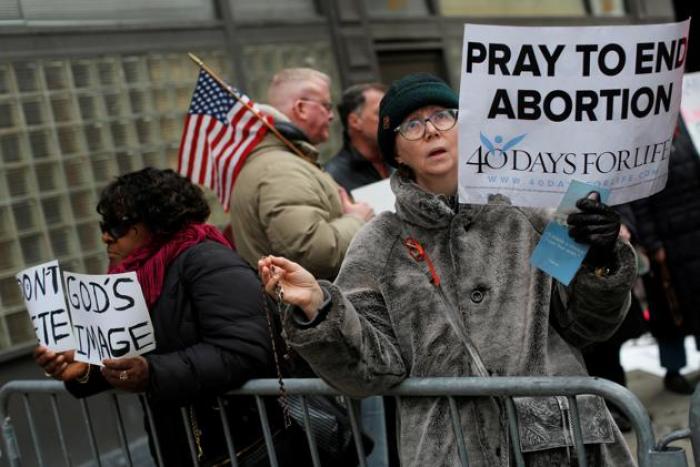 A woman prays during an anti-Planned Parenthood vigil outside the Planned Parenthood - Margaret Sanger Health Center in Manhattan, New York, U.S., February 11, 2017.