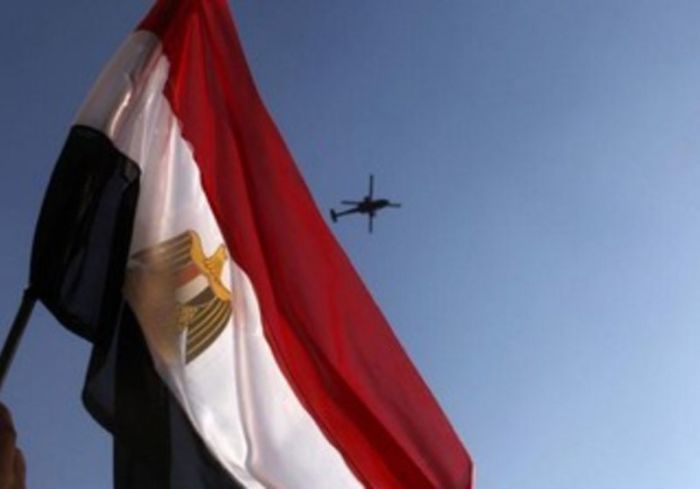 Egypt flag waving with helicopter in background.