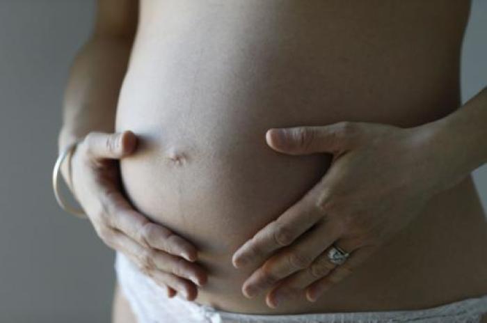 A pregnant woman, in the last trimester of her pregnancy, poses in this illustration photo in Sete, South France.