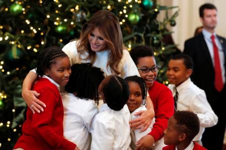 First lady Melania Trump hugs school children as she tours the holiday decorations, Washington D.C. November 27, 2017.